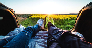 getting-pregnant-after-ovulation-couple-feet-shoes-outside-field-flowers-sunset | American Pregnancy Association