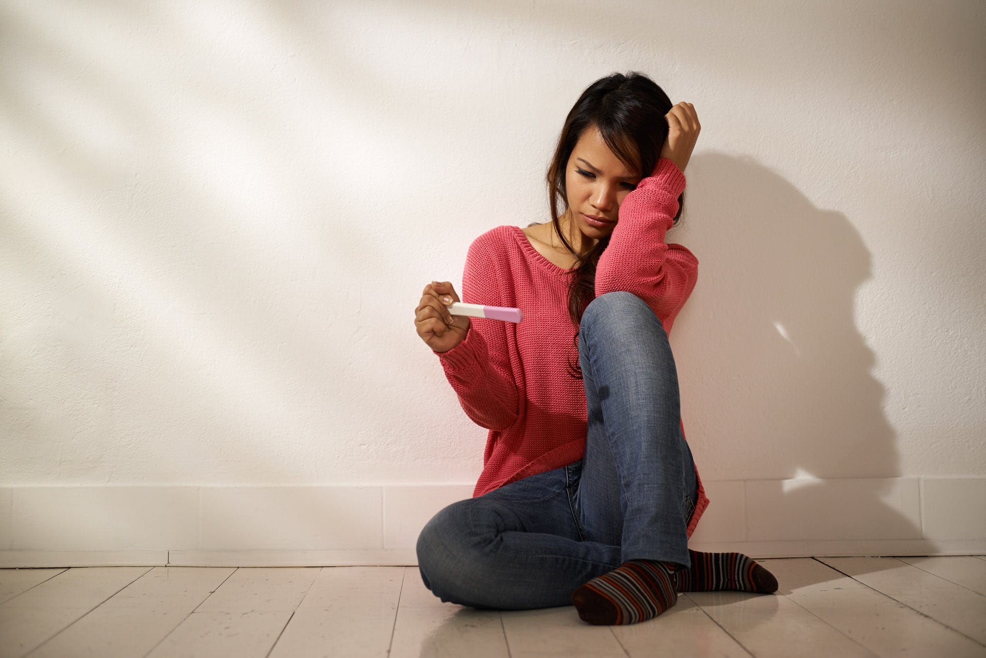 teenager-sad-scared-reading-pregnancy-test | American Pregnancy Association