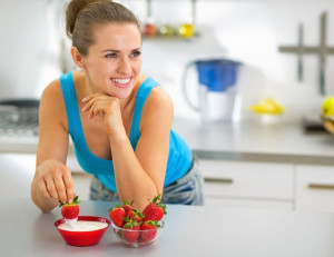where-to-get-probiotics-naturally-woman-kitchen-strawberries-dip-smiling | American Pregnancy Association